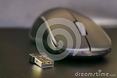Black wireless mouse with usb connector on dark background Stock Photo