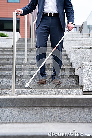 Close Up Of Blind Person Negotiating Steps Outdoors Using Cane Stock Photo