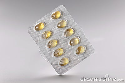 Blister with yellow jelly tablets, daily dose of medication for person Stock Photo