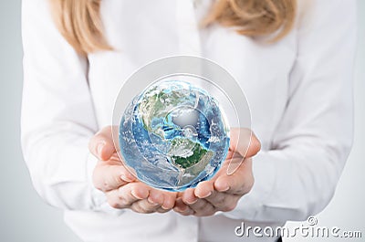 Close-up of blonde's hands who holds the globe with western hemisphere. A woman dressed in formal clothes. Stock Photo