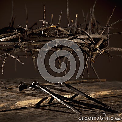 Close up bloody nails and crown of thorns as symbol of passion of Jesus Christ. Selective focus on nails Stock Photo