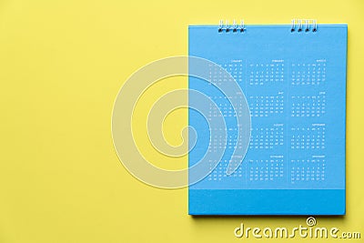 Close up of blue calendar on the yellow background Stock Photo