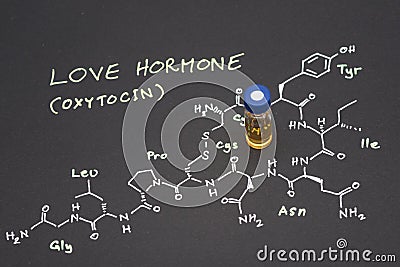 Close-up blue cap sample vial on paper with chemical formula of Stock Photo