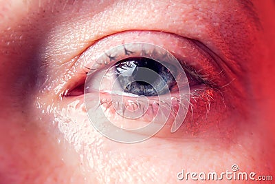 Close-up blue eye of a woman with a tear. People and emotions concept Stock Photo