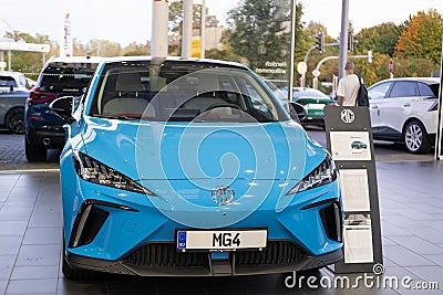 close-up blue MG Car model 4, electric Chinese company brand Nanjing Automobile in showroom, alternative energy, concept Editorial Stock Photo