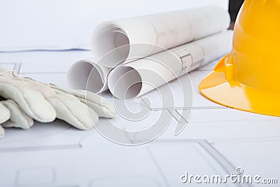Close-up of blue print and hard hat Stock Photo