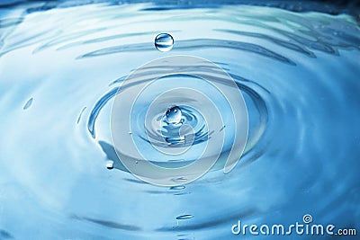 Close up blue water drop splash on water surface. Stock Photo