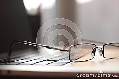 Close up.blurred image of businessman glasses on laptop keyboard Stock Photo