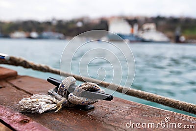 Close up of boat rope tied to nautical cleat hitch on boat Stock Photo