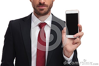 Close up of body of businessman presenting mobile phone Stock Photo