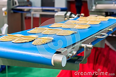Close up bologna sliced plate on conveyor of automatic slicer machine for industrial food manufacture Stock Photo