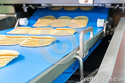 Close up bologna sliced plate on conveyor of automatic slicer machine for industrial food manufacture Stock Photo