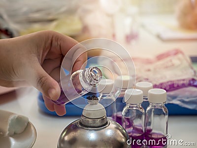 Close-up of bottle being sterilized with an alcohol burner before use in bacterial cultures. Medicine and microbiology concept Stock Photo