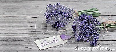Close up of bouguet of violet purple lavendula lavender flowers herbs with wooden pendant with the word: Stock Photo