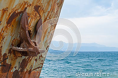 Close-up at the bow with anchor of corroded and abandoned shipwreck washed ashore. Stock Photo