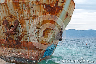 Close-up at the bow with anchors of corroded and abandoned shipwreck washed ashore. Stock Photo