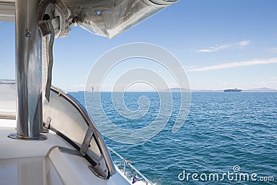 Close up bow of motorboat passing boats on the ocean Stock Photo