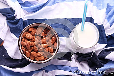 Top view of bowl of almond nuts and milk on table cloth Stock Photo