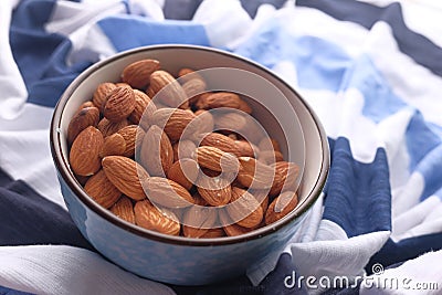 Close up of bowl of almond nuts on table cloth Stock Photo