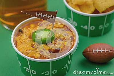 close up of bowl of chili with jalepeno pepper and football flag Editorial Stock Photo