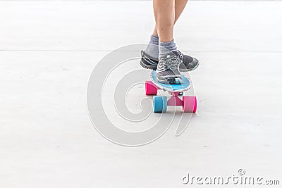 Close up of boy`s feet standing on modern short cruiser skateboa Stock Photo