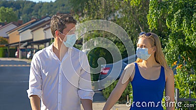CLOSE UP: Boyfriend and girlfriend go for a walk during the covid19 pandemic. Stock Photo