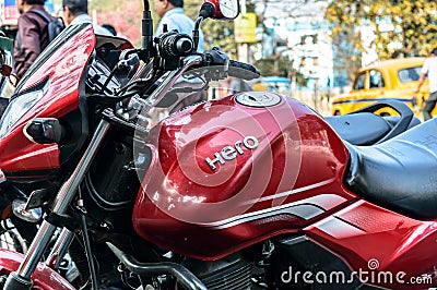 Close up Brand name Hero Honda motorcycle classic red model on fuel storage tank and engine control unit spotted on a roadside Editorial Stock Photo