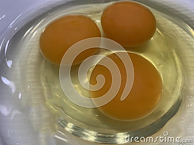 Close up breaking raw egg in bowl display Stock Photo