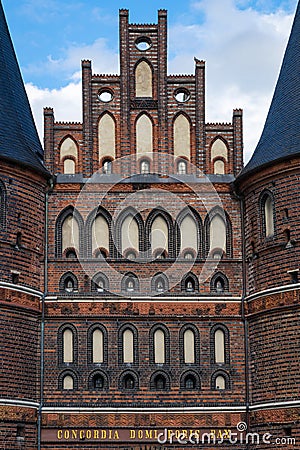 Close up of the brick-built Holsten Tor old city gate of LÃ¼beck reading the golden letters concordia domi foris pax Stock Photo