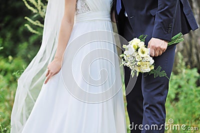 Close up of bride and groom hands. Wedding bouquet Stock Photo