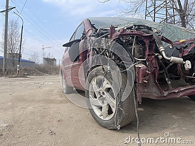 Close up of broken and abandoned car. Smashed car to pieces after accident on street. Concept of careless driving. Stock Photo