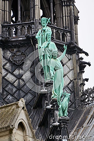 Close-up on bronze statues of the apostles at the base of the spire on the Notre Dame cathedral at Paris Editorial Stock Photo