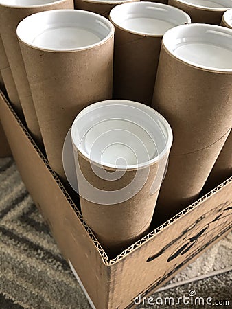 Close up of brown mailer tubes with white plastic caps Stock Photo