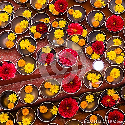 Close-up on Buddhist flower offerings in bowls. Stock Photo