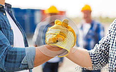 Close up of builders hands making handshake Stock Photo