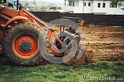 Close up of bulldozer scoop moving earth and doing landscaping works Stock Photo