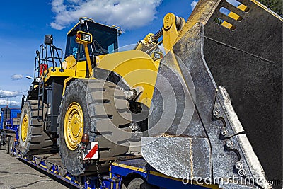 Close-up bulldozer on a transport platform. Concept: road construction, heavy construction equipment Stock Photo