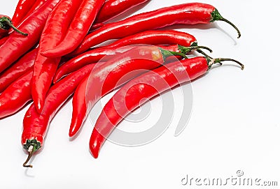 Close up of bunch of long red chili peppers on a white background isolated. It lies diagonally Stock Photo