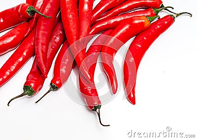 Close up of bunch of long red chili peppers on a white background isolated. It lies diagonally Stock Photo