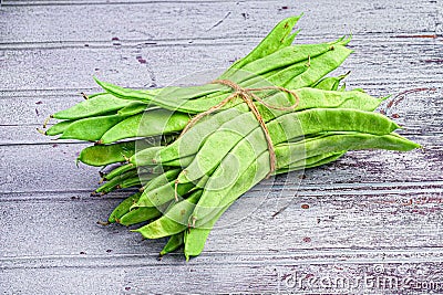 Close-up of a bundle of fresh green beans tied together with a brown string. Stock Photo