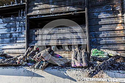 Close up Burned damaged ruins of destroyed supermarket metallic facade arson investigation insurance Stock Photo