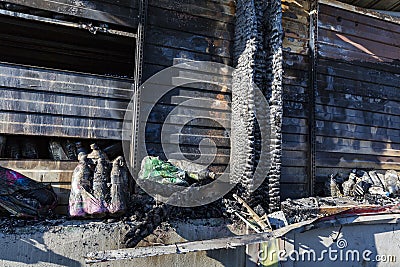 Close up Burned damaged ruins of destroyed supermarket metallic facade arson investigation insurance Stock Photo