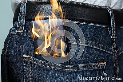 Burning Phone In Jeans Stock Photo