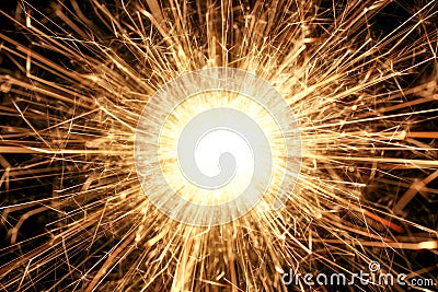 Burning sparkler firework with lots of hot glowing embers exploding. For New Years or 4th of July celebration Stock Photo