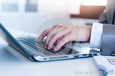 Close up of business man hands typing on laptop computer Stock Photo