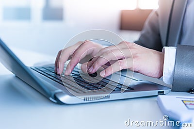 Close up of business man hands typing on laptop computer Stock Photo