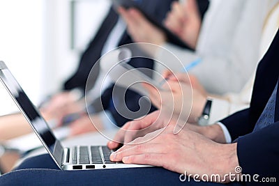 Close-up of business man hands typing on laptop computer at the conference Stock Photo