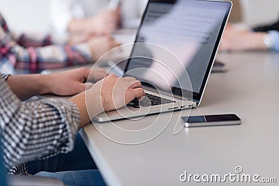 Close up of business man hands typing on laptop with team on mee Stock Photo