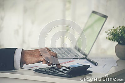 Close up business man hands using calculator counting tax financial bill. Man hands calculating number, data, graph, chart audit Stock Photo