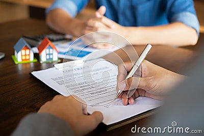 Close up of Business man pointing and signing agreement for buying house. Bank manager concept Stock Photo